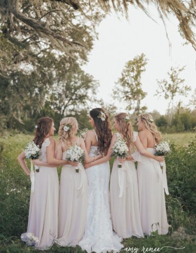 Bride and bridesmaids under mossy oak