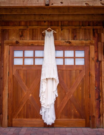Details shots are a part of your wedding photography you won't want to forget to request. We love this shot of a bridal gown hung on the front of the C Bar Ranch events barn in North Central Florida. Image by Jimmy Ho of www.jimmyhophotography.com