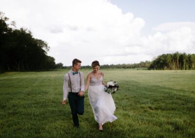 This bride longed to run barefoot in the grass with her new husband. We love this portrait of them, taken just after their ceremony, in a field behind the C Bar Ranch events barn, as their guests enjoyed cocktail hour.