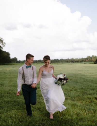 This bride longed to run barefoot in the grass with her new husband. We love this portrait of them, taken just after their ceremony, in a field behind the C Bar Ranch events barn, as their guests enjoyed cocktail hour.