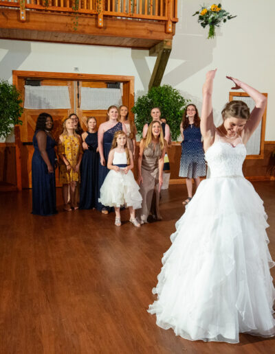 A bride tosses the bouquet on the dance floor at C Bar Ranch. Photo by footstonephotography.com of Gainesville, Florida.