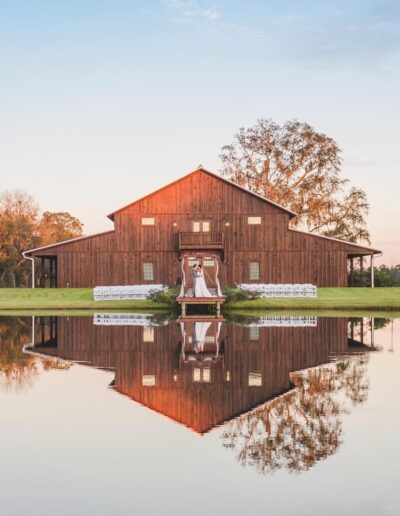 The barn reflecting in the pond makes for a unique and beautiful wedding day portrait. Photo by mattwhytsell.com of Starke, Florida.