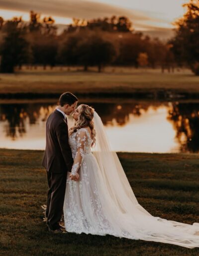 Bride and groom near the C Bar Ranch pond at golden hour.