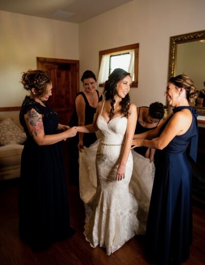 Bridesmaids help a bride get ready at C Bar Ranch.