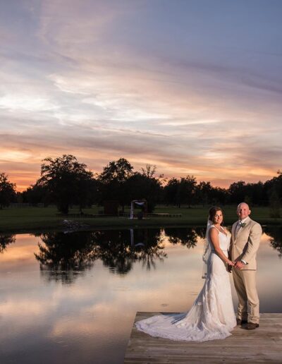 Bride and groom on the dock at sunset at C Bar Ranch.